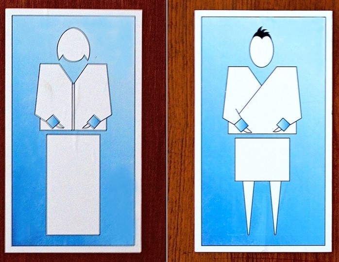 Restroom signs from the country of Bhutan display stylized representations of a woman and man dressed in traditional clothing. Restroom signs from the country of Bhutan display stylized representations of a woman and man dressed in traditional clothing.