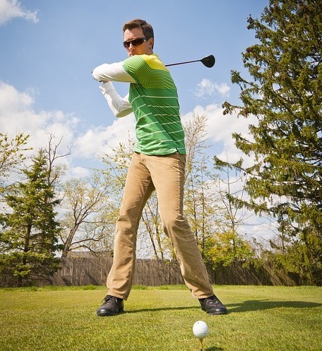 A golfer prepares to tee off.