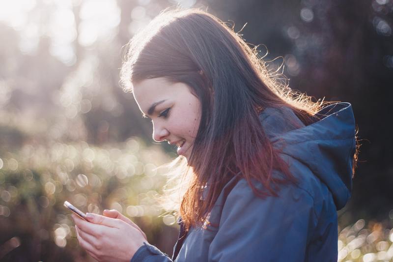 A young woman looking at her smart phone